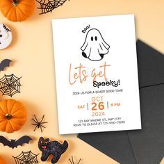 an image of a halloween party card with pumpkins and bats on the table next to it