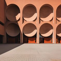 the building is made out of concrete and has round holes in it's walls