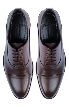 Handmade of smooth leather, this cap-toe dress shoe with a classic oxford silhouette offers a sophisticated, elegant look. Leather upper and lining/synthetic sole Made in Turkey Business Lace-up Cap Toe Shoes With Goodyear Welting, Classic Oxford Lace-up Shoes With Rubber Heel Cap, Classic Cap Toe Business Lace-up Shoes, Classic Fitted Oxford Lace-up Shoes, Business Casual Goodyear Welted Cap Toe Oxfords, Cap Toe Oxfords For Derby, Fitted Cap Toe Oxfords For Derby, Semi-formal Cap Toe Oxfords With Branded Insole, Elegant Brown Oxford Shoes With Leather Sole