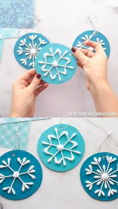 someone is making snowflakes out of paper and glue on the back of their ornaments