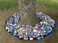 there is a tree that has been decorated with many different items on the ground around it