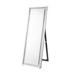 a large mirror sitting on top of a wooden stand with a black frame around it