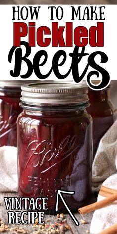 two jars filled with pickled beets on top of a table next to cinnamon sticks