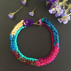 "A statement necklace in various multicoloured vivid hues, made out of sari silk ribbon. A bold piece of jewellery with a bohemian yet delicate spirit that suits many appearances.  Comes gift wrapped! Measurements Length from the neck= 17 cm (6,69 inch) Motif length= 2,5 cm (0,98 inch) Motif width= 16 cm (6,30 inch) Please, you are welcome to read my shop policies page (concerning shipping, refunds, returns, payment), BEFORE purchasing an item. Thank you! For even more silk crochet creations, feel free to visit my shop section \"silk crochet necklace\": https://www.etsy.com/shop/WearitCrochet?section_id=17463390&ref=shopsection_leftnav_2" Multicolor Crochet Bohemian Jewelry, Bohemian Multicolor Macrame Necklaces, Bohemian Multicolor Macrame Necklace, Vibrant Multicolor Handmade Necklaces, Multicolor Macrame Necklace For Festivals, Multicolor Bohemian Fair Trade Necklaces, Handmade Vibrant Rainbow Necklaces, Sari Silk Necklace, Sari Silk Jewelry