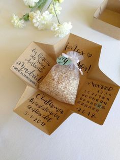 two bags of rice sitting on top of a table next to flowers and calendars