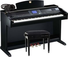 a black piano with a bench next to it and a keyboard on the top shelf