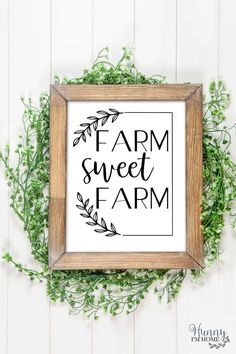 a framed sign with the words farm sweet farm in black and white, surrounded by greenery