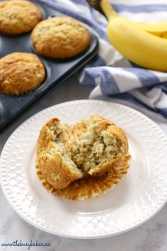 muffins on a white plate next to some bananas