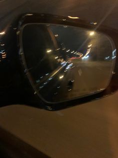 the side view mirror of a car at night