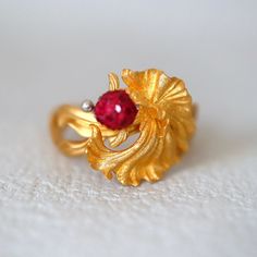 Personal Collection Gold Fish Ring. This is a super finely made piece of art. The body of the fish is of is super sparkly texture that glitters✨ under light and the band is in a velvety silky gold texture that reminds me of the most lovely ribbons. 🎀  💍Condition: Brand New & Custom Designed  💍Size: US 5-5.5 not sizable 🥲 ⭐️Metal: Solid 18K Yellow Gold ♥️Two types of gold textures super unique design. ⭐️Center Stone: 1mm rubies on the fish's head 💎Measurement: 14*14mm This item will be sent Elegant 14k Gold Fish-shaped Jewelry, Exquisite 14k Gold Ruby Ring, Elegant 22k Gold Ruby Ring, Elegant Fish-shaped Formal Jewelry, Exquisite Gold Ruby Ring With Prong Setting, Ring With Ruby, Fish Ring, Types Of Gold, Velvet Jewelry