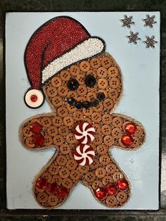 a gingerbread man with a santa hat and candy canes on it's face