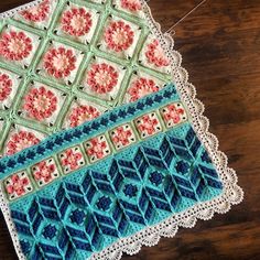 a crocheted doily on a wooden table next to a pair of scissors