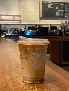 a cup of coffee sitting on top of a wooden table