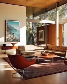 a living room filled with lots of furniture next to large windows on top of a hard wood floor