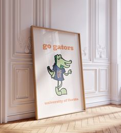 there is a poster on the floor in front of a wall with an alligator saying, go gators university of florida