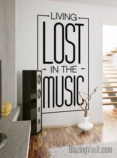 the living room wall decal is decorated with black and white lettering that reads, living lost in the music