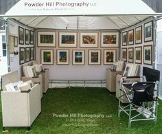 a tent with chairs and pictures on the wall