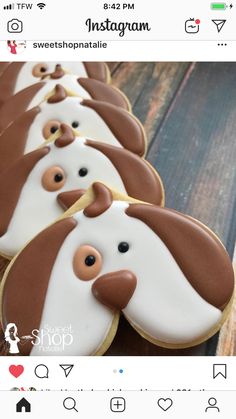 cookies decorated like dogs are lined up on a wooden table, with the words instagram above them