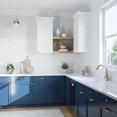 a kitchen with blue cabinets and white walls