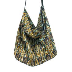 Pretty boho ethnic chic tote bag, handmade and eco-friendly, with handles and bottom made from recycled Italian leather. This handmade bag features a Khaki/Bronze leaf-shaped African graphic print on a Black background in 100% African Ankara cotton. Lined with black cotton canvas, it features a magnetic closure for added security.  Internal pocket matching the wax print and leather ties attached to a carabiner are also included, so you'll never lose your keys again.  Dimensions: Height without h Reversible Bohemian Shoulder Bag, Bohemian Reversible Shoulder Bag, Bohemian Reversible Hobo Bag For Daily Use, Bohemian Ethically Sourced Shoulder Bag For Everyday Use, Bohemian Reversible Hobo Tote Bag, Bohemian Reversible Hobo Bag For Travel, Bohemian Reversible Hobo Bag For Everyday Use, Green Bohemian Hobo Bag For Everyday, Ethnic Chic