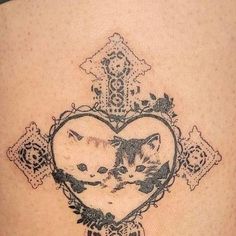 a heart shaped tattoo with two cats in it