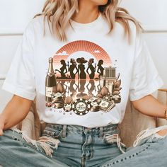 a woman sitting on a couch wearing a t - shirt with an image of three women