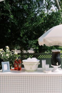 a table with an umbrella and dishes on it