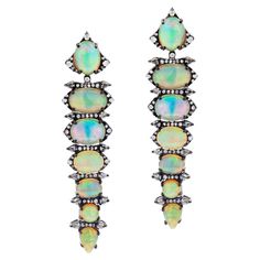 This Gemistry, Victorian 11.64 Ct. T.W. Diamond and Ethiopian Opal Drop Earrings features row of graduating drops of shinning round , oval and pear Ethiopian opals enclosed by pave diamond halos on a black rhodium polished 18k/925 surface. This diamond drop earring is embellished with mix diamonds, weighing 1.33 Cts. Mix cab Ethiopian opal stones heighten the look of the sterling silver earpieces. The posh earrings have push back. This earring pair radiates elegance. Please follow the Luxury Jew Opal Drop Earrings, Gold Chandelier Earrings, Diamond Drop Earrings, Black Rhodium, Opal Earrings, Ethiopian Opal, Chandelier Earrings, Halo Diamond, Pave Diamonds