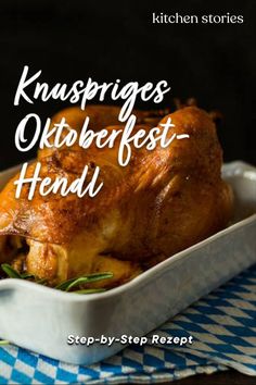 a close up of a chicken in a casserole on a blue and white checkered table cloth