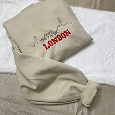 London Embroidered Crewneck/Sweatshirt  Hello there! Please message me if you have any additional questions or want to change thread colors. We are a family-run Etsy page; my husband and I make all orders from home. You can also send us a message if you would like a custom sweatshirt/t-shirt with whatever words and images, and we will see if we can accommodate your order! HOW TO ORDER - Please Choose the SIZE and COLOR From Drop Down Menu. MATERIAL - We use Jerzee and Gildan as our blanks; I may Long Sleeve Tops With Machine Embroidery For Streetwear, Winter Embroidered Crew Neck Hoodie, Cream Cotton Sweatshirt With Embroidered Logo, Embroidered Cream Cotton Sweater, Cream Embroidered Crew Neck Sweatshirt, Cream Embroidered Cotton Sweater, Cream Cotton Embroidered Sweater, Cream Crew Neck Sweatshirt With Letter Embroidery, Cream Cotton Sweatshirt With Letter Embroidery