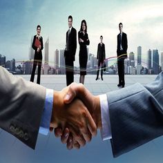 two men shaking hands in front of a group of business people with skyscrapers in the background