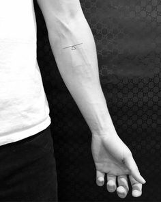 a person with a small tattoo on their arm