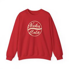 Custom Nuka Cola Crewneck Sweatshirt Step into the world of Fallout with our exclusive Nuka Cola crewneck sweatshirt, perfect for fans of Fallout New Vegas, Fallout 4, and Fallout 76. Designed for men and women ages 20-45, this unisex heavy blend crewneck sweatshirt is the ultimate addition to your Fallout cosplay or everyday wardrobe. 🎮Crafted from a medium-heavy fabric blend of 50% cotton and 50% polyester, this sweatshirt offers pure comfort and durability. The polyester-cotton mix ensures t Red Crew Neck Sweatshirt For Fan Merchandise, Red Crew Neck Sweatshirt For Fans, Pop Culture Letter Print Crew Neck Hoodie, Pop Culture Crew Neck Sweatshirt For Winter, Retro Crew Neck Sweatshirt For Fan Merchandise, Winter Crew Neck Pop Culture Sweatshirt, Winter Crew Neck Sweatshirt In Pop Culture Style, Winter Crew Neck Sweatshirt With Pop Culture Style, Pop Culture Fan Merchandise Crew Neck Sweatshirt