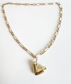 The Penelope puffy heart charm necklace is a show stopper. It’s a fun, chunky and playful charm This large 3D charm is a fav Chunky Heart-shaped Gold Necklace, Chunky Heart Pendant Jewelry Gift, Chunky Heart-shaped Jewelry Gift, Chunky Heart Pendant Necklace For Valentine's Day, Chunky Heart Necklace For Valentine's Day, Chunky Heart Pendant Necklace As Gift, Chunky Heart-shaped Jewelry For Valentine's Day, Valentine's Day Chunky Heart Jewelry, Gold Chunky Heart Necklace