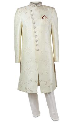 Off-White Sherwani suit is covered in delicate while, gold, and red embroidery. Elegant Beige Sets With Gold Embroidery, Gold Silk Sherwani For Eid, Elegant Cream Traditional Wear For Festive Occasions, Formal Cream Sets With Pearl Embroidery, Elegant Cream Sherwani With Intricate Embroidery, Elegant Off White Sherwani With Resham Embroidery, Designer Wedding Sets With Pearl Embroidery, Ceremonial Cream Nehru Jacket With Zari Work, Elegant Kurta With Gold Embroidery And Traditional Drape