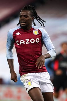 a man with dreadlocks is playing soccer