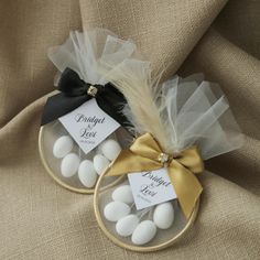 two small baskets filled with white and black candies on top of a burlock