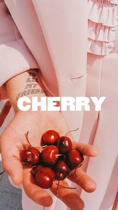 a person holding cherries in their hands with the words cherry written on top of them