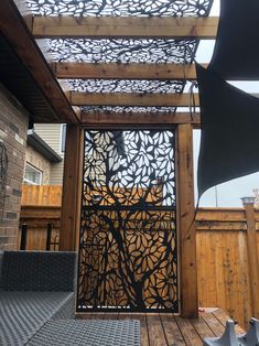 a wooden deck with an iron screen on it