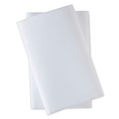 two white sheets are folded on top of each other in front of a white background