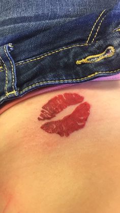 a woman's stomach with red lipstick imprint on it