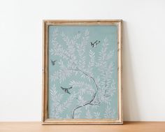 a painting on a wall with birds flying over the tree branch and leaves in front of it