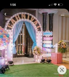 a decorated stage with balloons and lights for a baby's first birthday or wedding