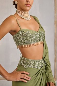 Sage green pre-draped saree with sequin, cutdana, bead embroidered waistband and detachable drape. Paired with sleeveless embroidered padded blouse. - Aza Fashions Green Draped Choli For Reception, Fitted Green Draped Sets, Draped Saree, Padded Blouse, Drape Saree, Saree With Blouse, Sweetheart Neck, Aza Fashion, Floral Embroidery