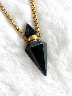 Introducing our exquisite Black Obsidian Potion Bottle Pendant Necklace! Crafted from the powerful obsidian stone, this pendant takes on the captivating form of a hexagonal pendulum crystal point. The intricate design doesn't stop there - the topper, adorned in a painted hexagon shape, unscrews to reveal a hidden compartment within. This compartment is your personal canvas, perfect for storing essential oils, cherished ashes, or any meaningful material of your choosing. To complement this stunni Obsidian Gemstone Necklace For Gift, Spiritual Obsidian Necklace As Gift, Elegant Obsidian Jewelry Gift, Black Obsidian Necklace Gift, Elegant Obsidian Jewelry For Healing, Elegant Obsidian Jewelry For Gift, Black Obsidian Necklace For Gift, Black Obsidian Necklace For Healing, Gold Spiritual Obsidian Jewelry