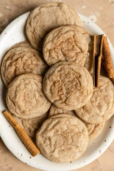 cinnamon spice cookies on a white plate with cinnamon sticks