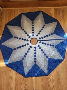 a blue and white quilted table top with a star design on it's center