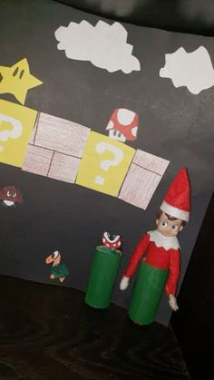 an elf is standing in front of a blackboard with the letter q on it