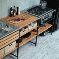 a kitchen with an oven, sink and cutting board