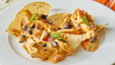 a white plate topped with nachos and tortilla chips